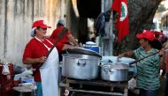 Supporters of former Brazilian President Luiz Inacio Lula da Silva cooking in a camp near the Federal Police headquarters, where Lula is imprisoned, in Curitiba, Brazil. April 9, 2018. Reuters/Rodolfo Buhrer