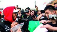 Mercedes' British driver Lewis Hamilton (L) signs autographs prior to the Formula One Chinese Grand Prix in Shanghai on April 12, 2018. AFP / Johannes Eisele