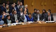  British Ambassador to the UN Karen Pierce (L) and US Ambassador to the UN Nikki Haley (C) vote during a UN Security Council meeting, at the United Nations Headquarters in New York, on April 14, 2018. / AFP / HECTOR RETAMAL 