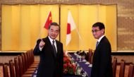 Japan's Foreign Minister Taro Kono (R) and his Chinese counterpart Wang Yi (L) arrive for their meeting in Tokyo on April 15, 2018. / AFP / POOL / Behrouz MEHRI