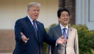 (FILES) In this file photo taken on November 5, 2017, US President Donald Trump (L) gestures as he speaks with Japan's Prime Minister Shinzo Abe upon his arrival for a luncheon at the Kasumigaseki Country Club Golf Course in Kawagoe, Saitama, outside Toky