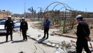 Syrian traffic police stand in the street in Douma on the outskirts of Damascus on April 16, 2018 during an organised media tour after the Syrian army declared that all anti-regime forces have left Eastern Ghouta, following a blistering two month offensiv