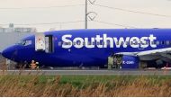 Emergency personnel monitor the damaged engine of Southwest Airlines Flight 1380, which diverted to the Philadelphia International Airport after the airline crew reported damage to one of the aircraft's engines, on a runway in Philadelphia, Pennsylvania U