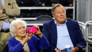 File photo of (L-R) Former First Lady Barbara Bush and former President George H.W. Bush looking on prior to the South Regional Final of the 2015 NCAA Men's Basketball Tournament between the Duke Blue Devils and the Gonzaga Bulldogs at NRG Stadium on Marc