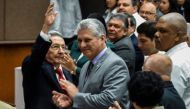 Cuban President Raul Castro (L) waves next to First Vice-President Miguel Diaz-Canel (C) during a National Assembly session that will select Cuba's Council of State ahead of the naming of a new president, in Havana on April 18, 2018.  AFP / STR
