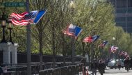A US national flag, French flag(C) and Washington DC flag fly near the White House in Washington, DC on April 20, 2018, the week before the visit of French President Emmanuel Macron. AFP / Andrew CABALLERO-REYNOLDS