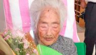 Nabi Tajima, born in 1900, holds a bouquet in Japanese southwestern island of Kikaijima, Kagoshima Prefecture, Japan, in this photo taken in 2015 and released by Kyodo.