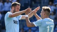 Lazio's Italian midfielder Ciro Immobile (R) celebrates with Lazio's Dutch defender Stefan de Vrij after scoring a goal during the Italian Serie A football match Lazio versus Sampdoria on April 22, 2018 at Rome's Olympic Stadium. / AFP / Andreas SOLARO