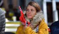 A woman stands in honour of Anzac Day during the Super Rugby match between the Canterbury Crusaders of New Zealand and the Sunwolves of Japan in Christchurch on April 21, 2018. AFP / Marty Melville