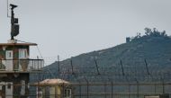 File photo of a North Korean propaganda speaker (top C) behind a South Korean military guard post (L) seen across the Demilitarized Zone (DMZ) separating the two countries from the South Korean island of Ganghwa, September 9, 2017.  / AFP / Ed JONES 