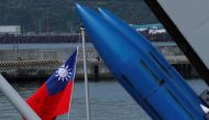 A Taiwanese flag is seen behind standard Type II missiles on Kee Lung (DDG-1801) destroyer during a drill near Yilan naval base, Taiwan. Reuters/Tyrone Siu
