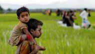 A Rohingya boy carries a child after after crossing the Bangladesh-Myanmar border in Teknaf, Bangladesh, September 1, 2017. Reuters/Mohammad Ponir Hossain
