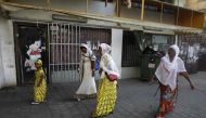 This file photo taken on September 2, 2017 shows Christian African Eritrean migrants walking outside at a makeshift church in southern Tel Aviv (AFP / Menahem Kahana) 