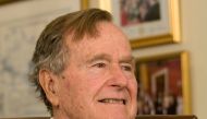 Former President George H.W. Bush smiles as he listens to Republican presidential candidate Mitt Romney speak as he met with Bush to pick up his formal endorsement in Houston, Texas, U.S. March 29, 2012. Reuters/Donna Carson