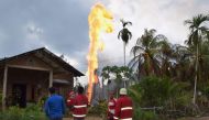 Indonesian fire fighters battle to extinguish a fire at an illegal oil well in Peureulak on April 25, 2018. At least 10 people have been killed and dozens more injured after a fire at an illegal oil well in Indonesia's Aceh province, authorities said on A