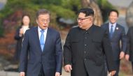 North Korea's leader Kim Jong Un (R) and South Korea's President Moon Jae-in (L) walk together after a tree-planting ceremony at the truce village of Panmunjom on April 27, 2018. AFP / Korea Summit Press Pool / Korea Summit Press Pool
