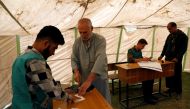 Afghan men arrive at a voter registration centre to register for the upcoming parliamentary and district council elections in Kabul, Afghanistan April 23, 2018. REUTERS/Mohammad Ismail