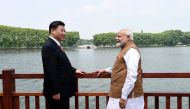 Chinese President Xi Jinping and India's Prime Minister Narendra Modi speak as they walk along the East Lake in Wuhan, China, April 28, 2018.

