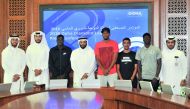 Hamad Issa Al Fadalah (centre), Secretary-General of Qatar Athletics Federation (QAF) poses for a photograph with QAF officials and some of the star Qatari athletes during a press conference held at Qatar Olympic Committee headquarters yesterday. Picture: