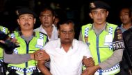 (FILES) In this file photo taken on November 5, 2015 Indonesian police escort Indian national Chhota Rajan (C) from Bali police headquarters to Ngurah Rai Airport during his deportation from Denpasar on Bali island. AFP / Sonny Tumbelaka 