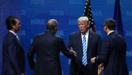 Donald Trump Jr., NRA Executive Vice President Wayne LaPierre, U.S. President Doanld Trump and Executive Director NRA-ILA Chris Cox shake hands at the NRA-ILA Leadership Forum during the NRA Annual Meeting & Exhibits at the Kay Bailey Hutchison Convention