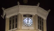 A photo taken on May 5, 2018 after midnight shows a general view of a clock above the central railway station in Pyongyang.  AFP / KIM Won-Jin
