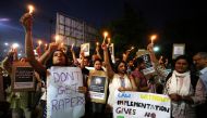 People hold candles and placards during a protest against the rape of an eight-year-old girl, in Kathua, near Jammu, a teenager in Unnao, Uttar Pradesh, and an eleven-year-old girl in Surat, Gujarat, in Ahmedabad, Indiia, April 16, 2018. Reuters/Amit Dave