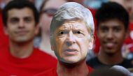 A fan wears a mask of Arsenal's French manager Arsene Wenger during the English Premier League football match between Arsenal and Burnley at the Emirates Stadium in London on May 6, 2018.  AFP / IKIMAGES / Ian Kington