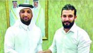 Al Kharaitiyat’s Football Head Mansoor Moussa (left) and their new head coach Nassif Al Bayawi pose for a photograph following the signing of agreement yesterday. 