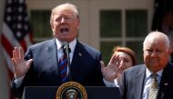 FILE PHOTO: U.S. President Donald Trump gives remarks on tax cuts for American workers as Richard Kerzetski of Universal Plumbing, North Las Vegas, Nevada, listens during an event in the White House Rose Garden in Washington, U.S., April 12, 2018. REUTERS