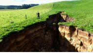This frame grab from TVNZ video footage taken on May 2, 2018 and released to AFP on May 7 shows a sinkhole that appeared on a dairy farm near Rotorua on New Zealand's North Island. AFP Photo / TVNZ
