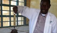 A fish farmer weighs a harvested catfish in Meru County, Kenya, April 25, 2018. Thomson Reuters Foundation/Caroline Wambui