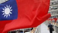 A man walks past a row of Taiwan's national flags in Taipei, October 14, 2011. REUTERS/Pichi Chuang
