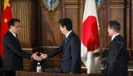 Chinese Premier Li Keqiang (C - L), Japanese Prime Minister Shinzo Abe (C) and South Korean President Moon Jae-in (C - R) attend the trilateral summit in Tokyo Wednesday, May 9, 2018. ( KIMIMASA MAYAMA / Anadolu 
