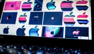 (FILES) In this file photo taken on March 23, 2018 shows Apple logos on a computer screen in Beijing. AFP / NICOLAS ASFOURI
