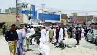 Policemen and security officers gather to collect evidence at the site of a blast, after a motorcycle exploded near a bus terminal in Bannu, Pakistan May 11, 2018. Reuters/Zahid Mohammad