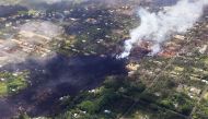 Smoke and volcanic gases rise as lava cools in the Leilani Estates neighborhood, in the aftermath of eruptions and lava flows from the Kilauea volcano on Hawaii's Big Island, on May 11, 2018 in Pahoa, Hawaii. Mario Tama/Getty Images/AFP