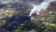 Smoke and volcanic gases rise as lava cools in the Leilani Estates neighborhood, in the aftermath of eruptions and lava flows from the Kilauea volcano on Hawaii's Big Island, on May 11, 2018 in Pahoa, Hawaii. Mario Tama/AFP