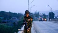 This picture taken on May 12, 2018 shows an army-linked militiaman securing a bridge in Muse. AFP