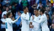 Real Madrid's Welsh forward Gareth Bale (R) celebrates a goal with teammates during the Spanish league football match between Real Madrid and Celta Vigo at the Santiago Bernabeu stadium in Madrid on May 12, 2018. / AFP / Benjamin CREMEL