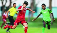 Young players in action during the Aspire Academy Tri-Series football tournament. 