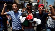 Mourners carry the body of eight-month-old Palestinian infant Laila al-Ghandour, who died after inhaling tear gas during a protest against U.S embassy move to Jerusalem at the Israel-Gaza border, during her funeral in Gaza City May 15, 2018. REUTERS/Moham