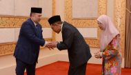 Malaysian politician Anwar Ibrahim and his wife Wan Azizah greet King Sultan Muhammad V at National Palace in Kuala Lumpur, Malaysia May 16, 2018. National Palace/Roskhadijah/Handout via Reuters