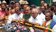 India's ruling Bharatiya Janata Party (BJP) leader and former Chief Minister of the southern state of Karnataka B. S. Yeddyurappa speaks with the media after meeting with the state governor to stake claim to form the government, outside the governor's hou