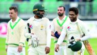 Pakistan's Imam-ul-Haq (R) and Khan Shadab celebrate after beating Ireland on the final day of Ireland's inaugural test match against Pakistan at Malahide cricket club, in Dublin on May 15, 2018. AFP / Paul Faith