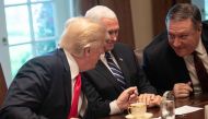 US President Donald Trump speaks (R) with Secretary of State Mike Pompeo as Vice President Mike Pence (C) looks on during a meeting with NATO Secretary General Jens Stoltenberg in the Cabinet Room at the White House in Washington, DC, on May 17, 2018. AFP