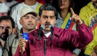 Venezuelan President Nicolas Maduro holds the political constitution after the National Electoral Council (CNE) announced the results of the voting on presidential election, on May 20, 2018, in Caracas, Venezuela.   AFP / Juan BARRETO

