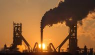 The sun rising above Tata Steels blast furnaces at their Scunthorpe Plant in north east England (AFP file photo /  Lindsey Parnaby) 