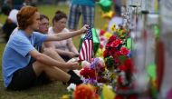Mourners gather at a makeshift memorial left in memory of the victims killed in a shooting at Santa Fe High School in Santa Fe, Texas, U.S., May 21, 2018. REUTERS/Jonathan Bachman