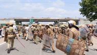 Indian police officials run towards protestors in the southern Indian city of Tuticorin some 600 kilometres (375 miles) south of Chennai on May 22, 2018, during a protest rally held to demand the closure of a copper factory due to pollution concerns. AFP 